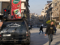 Residents walk near a Christian funeral car in Aleppo, Syria, on December 1, 2024, after the Syrian armed opposition seizes control of the c...