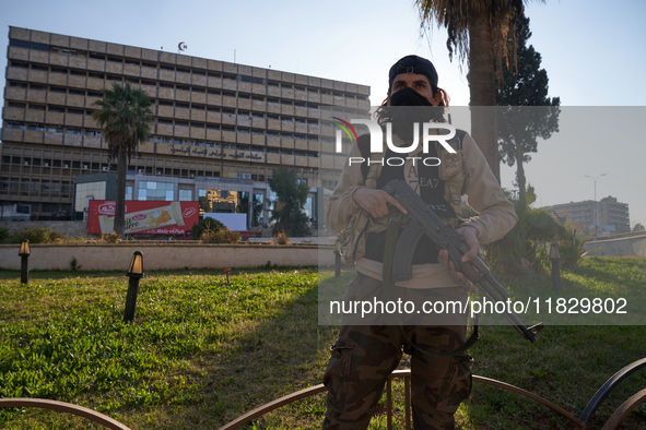 A Syrian armed opposition fighter stands to protect a vital location in Aleppo, Syria, on December 1, 2024.  