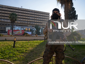 A Syrian armed opposition fighter stands to protect a vital location in Aleppo, Syria, on December 1, 2024.  (