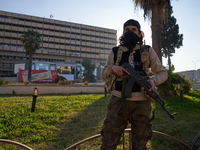 A Syrian armed opposition fighter stands to protect a vital location in Aleppo, Syria, on December 1, 2024.  (