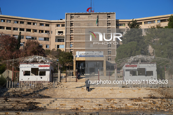 A man ascends the stairs of the university hospital that the Syrian regime strikes with airstrikes after the armed opposition takes control...