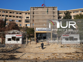 A man ascends the stairs of the university hospital that the Syrian regime strikes with airstrikes after the armed opposition takes control...