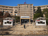 A man ascends the stairs of the university hospital that the Syrian regime strikes with airstrikes after the armed opposition takes control...