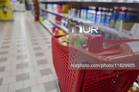 A detailed view of a shopping cart in the aisle of a modern supermarket in Barletta, Italy, on December 1, 2024.   