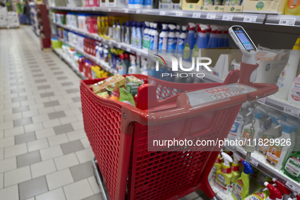 A detailed view of a shopping cart in the aisle of a modern supermarket in Barletta, Italy, on December 1, 2024.   