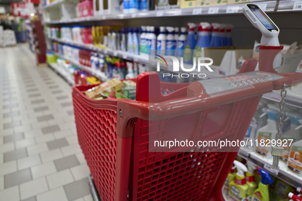 A detailed view of a shopping cart in the aisle of a modern supermarket in Barletta, Italy, on December 1, 2024.   