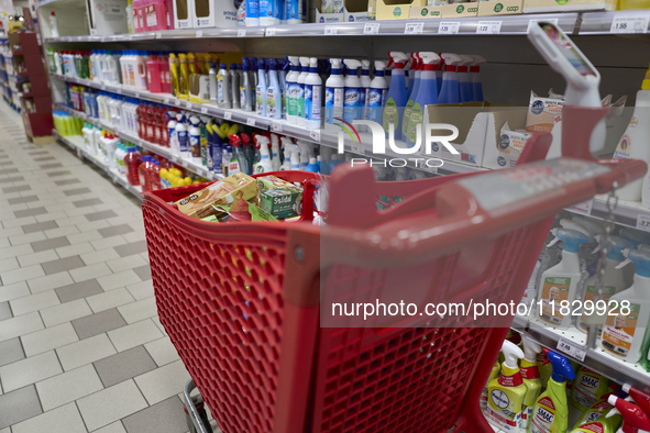 A detailed view of a shopping cart in the aisle of a modern supermarket in Barletta, Italy, on December 1, 2024.   