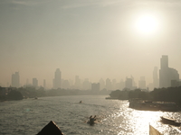 The cityscape of Bangkok, Thailand, is shrouded in a thick blanket of dust and pollution. The heavy air pollution, laden with fine particula...