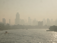 The cityscape of Bangkok, Thailand, is shrouded in a thick blanket of dust and pollution. The heavy air pollution, laden with fine particula...