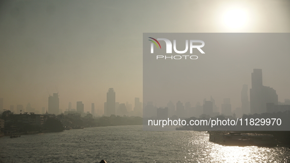 The cityscape of Bangkok, Thailand, is shrouded in a thick blanket of dust and pollution. The heavy air pollution, laden with fine particula...