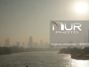 The cityscape of Bangkok, Thailand, is shrouded in a thick blanket of dust and pollution. The heavy air pollution, laden with fine particula...