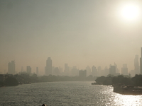 The cityscape of Bangkok, Thailand, is shrouded in a thick blanket of dust and pollution. The heavy air pollution, laden with fine particula...