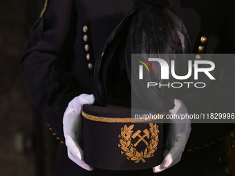 WIELICZKA, POLAND - DECEMBER 02:   
A miner holds a traditional 'Czako,' a ceremonial mining cap, which is part of the formal mining uniform...