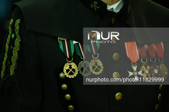 WIELICZKA, POLAND - DECEMBER 02:   
A miner proudly carries medals and badges he received during his career, pictured during the celebration...