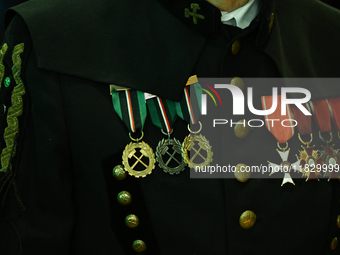 WIELICZKA, POLAND - DECEMBER 02:   
A miner proudly carries medals and badges he received during his career, pictured during the celebration...