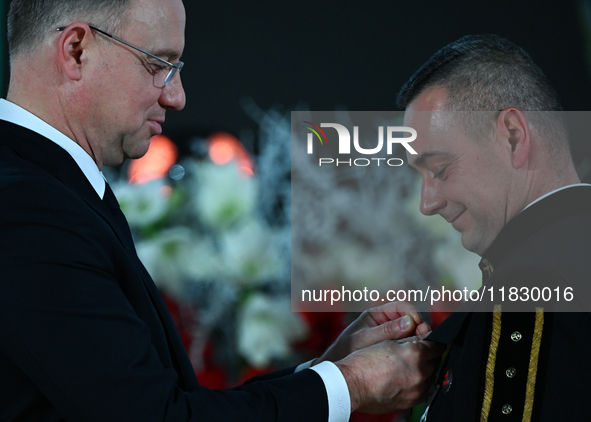 WIELICZKA, POLAND - DECEMBER 02:   
President of Poland, Andrzej Duda (L), decorates distinguished employees of the Wieliczka Salt Mine duri...