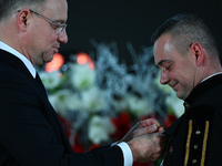 WIELICZKA, POLAND - DECEMBER 02:   
President of Poland, Andrzej Duda (L), decorates distinguished employees of the Wieliczka Salt Mine duri...