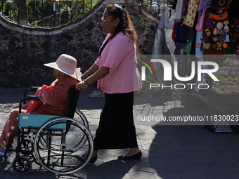 Visitors attend the Christmas Bazaar in the Tlahuac municipality in Mexico City, Mexico, on December 2, 2024, where the capital offers the s...