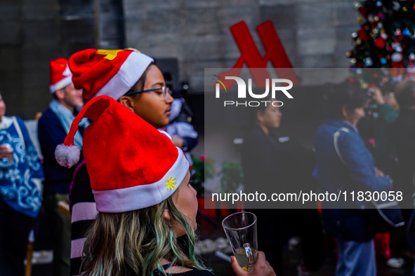 People participate in the Christmas tree lighting ceremony at the Marriott Hotel in Kathmandu, Nepal, on December 1, 2024. 