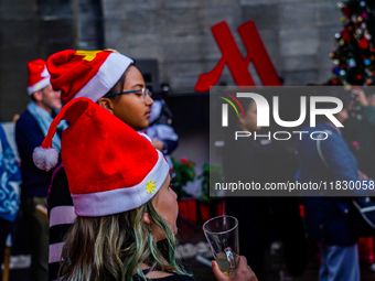 People participate in the Christmas tree lighting ceremony at the Marriott Hotel in Kathmandu, Nepal, on December 1, 2024. (