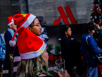 People participate in the Christmas tree lighting ceremony at the Marriott Hotel in Kathmandu, Nepal, on December 1, 2024. (