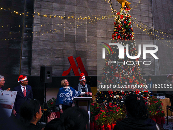 People participate in the Christmas tree lighting ceremony at the Marriott Hotel in Kathmandu, Nepal, on December 1, 2024. (