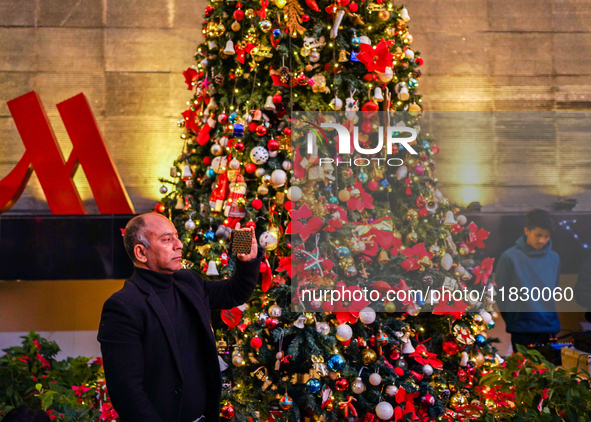 People participate in the Christmas tree lighting ceremony at the Marriott Hotel in Kathmandu, Nepal, on December 1, 2024. 