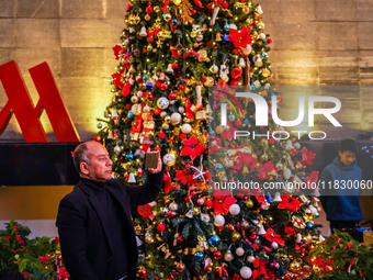 People participate in the Christmas tree lighting ceremony at the Marriott Hotel in Kathmandu, Nepal, on December 1, 2024. (