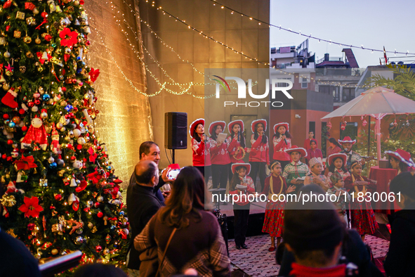 People participate in the Christmas tree lighting ceremony at the Marriott Hotel in Kathmandu, Nepal, on December 1, 2024. 