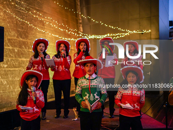 People participate in the Christmas tree lighting ceremony at the Marriott Hotel in Kathmandu, Nepal, on December 1, 2024. (