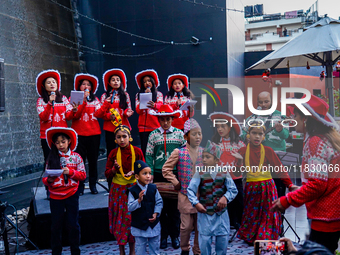 People participate in the Christmas tree lighting ceremony at the Marriott Hotel in Kathmandu, Nepal, on December 1, 2024. (