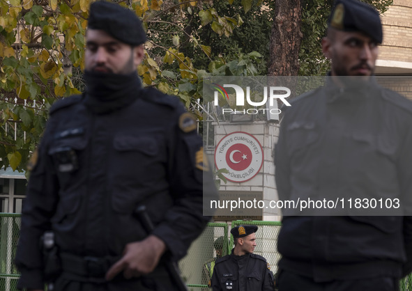 Iranian police stand guard outside the Turkish embassy during a protest against Turkish President Recep Tayyip Erdogan and his diplomacy reg...