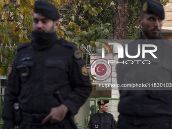 Iranian police stand guard outside the Turkish embassy during a protest against Turkish President Recep Tayyip Erdogan and his diplomacy reg...