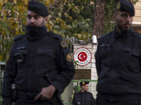 Iranian police stand guard outside the Turkish embassy during a protest against Turkish President Recep Tayyip Erdogan and his diplomacy reg...