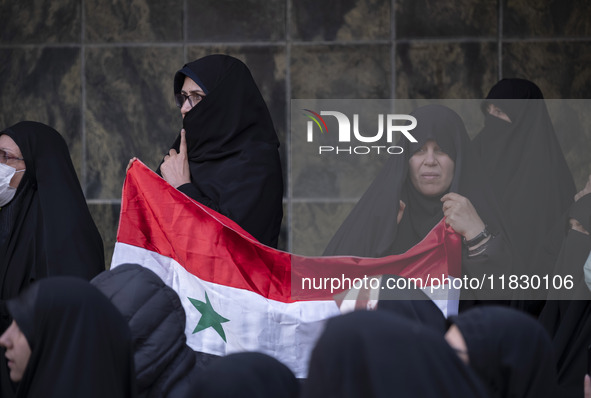 Iranian female protesters hold a flag of Syria while participating in a protest against Turkish President Recep Tayyip Erdogan and his diplo...