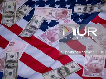 Copies of the U.S. Dollar and Turkish Lira banknotes are placed by Iranian protesters on the U.S. flag during a protest against Turkish Pres...