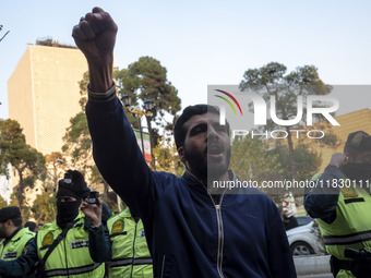 An Iranian protester shouts anti-U.S. and anti-Turkish President slogans while taking part in a protest against Turkish President Recep Tayy...