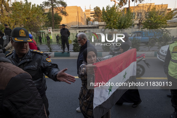 A female Iranian protester holds a flag of Syria while participating in a protest against Turkish President Recep Tayyip Erdogan and his dip...