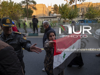 A female Iranian protester holds a flag of Syria while participating in a protest against Turkish President Recep Tayyip Erdogan and his dip...