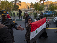 A female Iranian protester holds a flag of Syria while participating in a protest against Turkish President Recep Tayyip Erdogan and his dip...