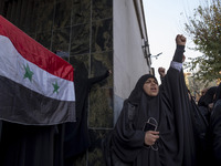 A female Iranian protester holds a flag of Syria as another veiled protester shouts anti-Turkish President slogans. They participate in a pr...