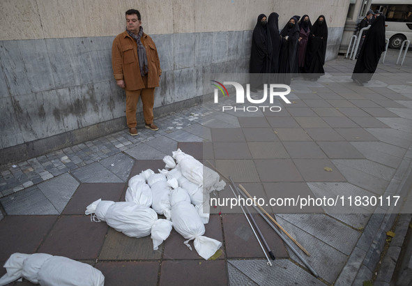 Packages wrapped in shrouds symbolizing the bodies of people of Syria are placed on a sidewalk during a protest against Turkish President Re...