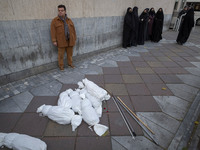 Packages wrapped in shrouds symbolizing the bodies of people of Syria are placed on a sidewalk during a protest against Turkish President Re...