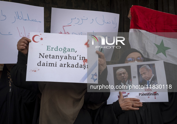 Iranian female protesters hold a flag of Syria and anti-Turkish President placards during a protest against Turkish President Recep Tayyip E...