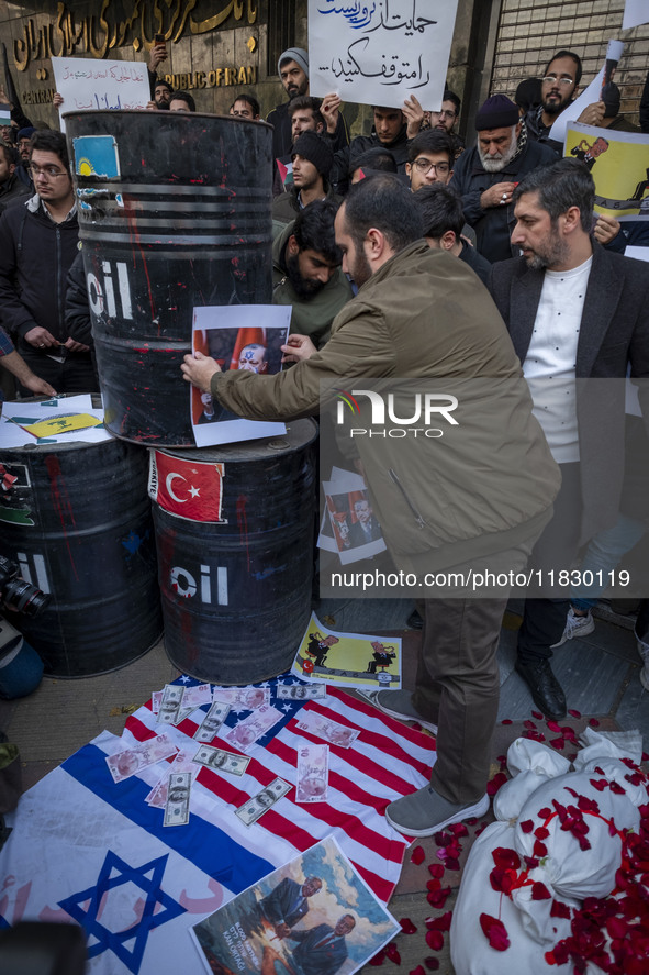 Copies of the U.S. Dollar and Turkish Lira banknotes, along with a poster featuring portraits of Turkish President Recep Tayyip Erdogan and...