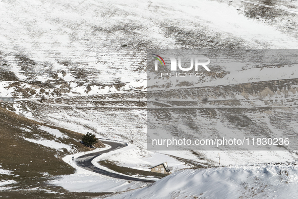 A winding road through snowy hills is seen in Campo Imperatore, Gran Sasso d'Italia, Italy, on November 16, 2024.  