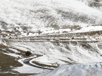 A winding road through snowy hills is seen in Campo Imperatore, Gran Sasso d'Italia, Italy, on November 16, 2024.  (