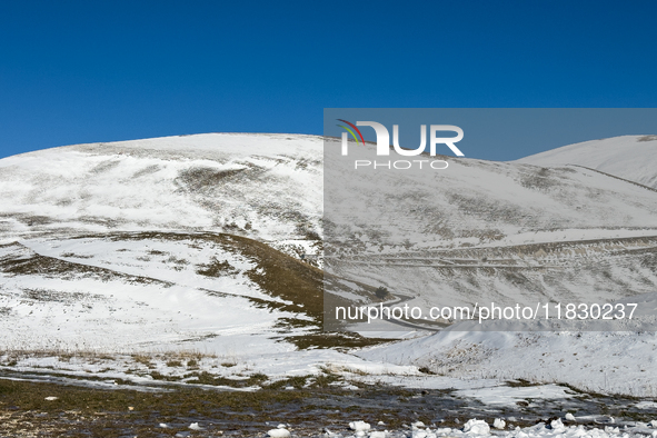 A winding road through snowy hills is seen in Campo Imperatore, Gran Sasso d'Italia, Italy, on November 16, 2024.  