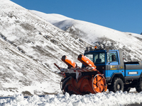 A snowplow clears freshly fallen snow against a backdrop of snowy hills in Campo Imperatore, Gran Sasso d'Italia, Italy, on November 16, 202...