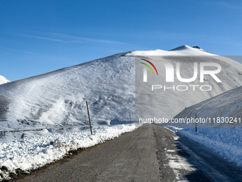 A winding road through snowy hills is seen in Campo Imperatore, Gran Sasso d'Italia, Italy, on November 16, 2024.  (